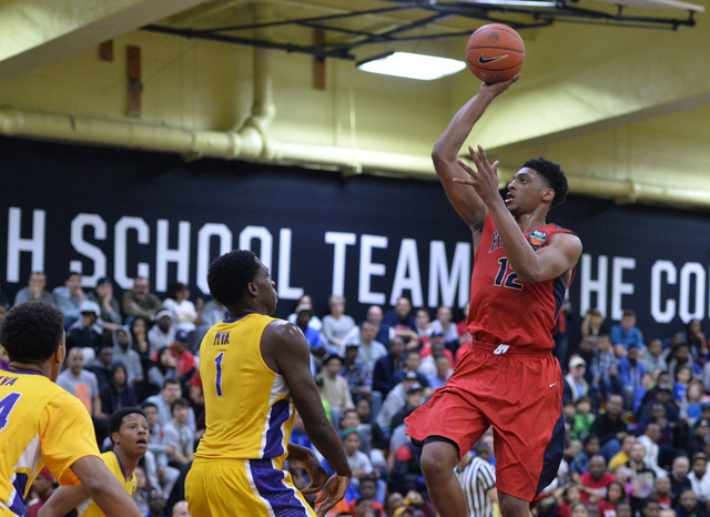 Findlay Prep Pilots junior Justin Jackson (12) shoots the ball over Montverde Academy Eagles ...