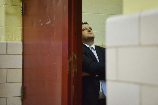 Findlay Prep Pilots head coach Andy Johnson tucks himself behind a doorway to collect himsel ...