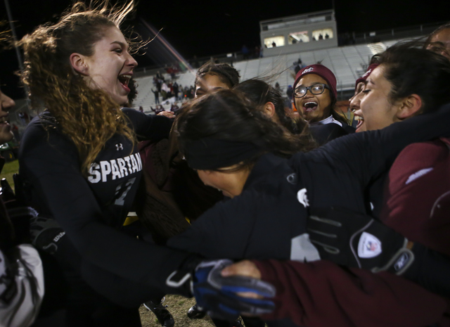 Cimarron-Memorial players, including Alyssa Karpinski (17), left, celebrate after defeating ...