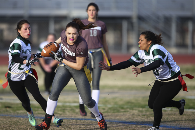 Cimarron-Memorial’s Logan DeLong (4) runs the ball between Palo Verde’s Jordan S ...