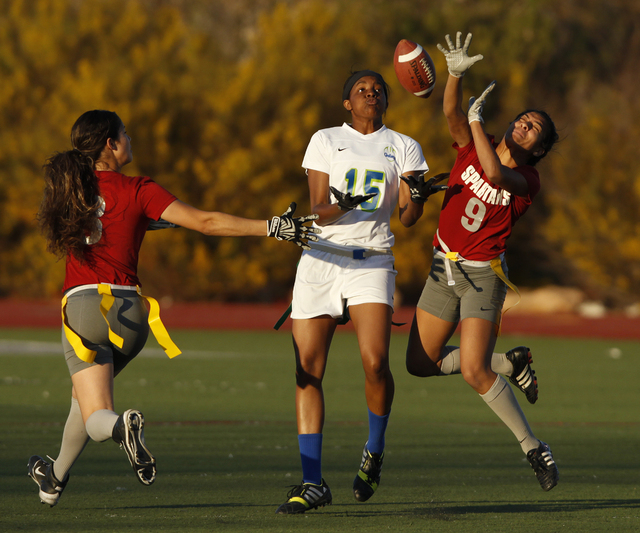 Cimarron-Memorial’s Tiana Callejo, right, and Rosie Del Rosario, left, break up a pas ...