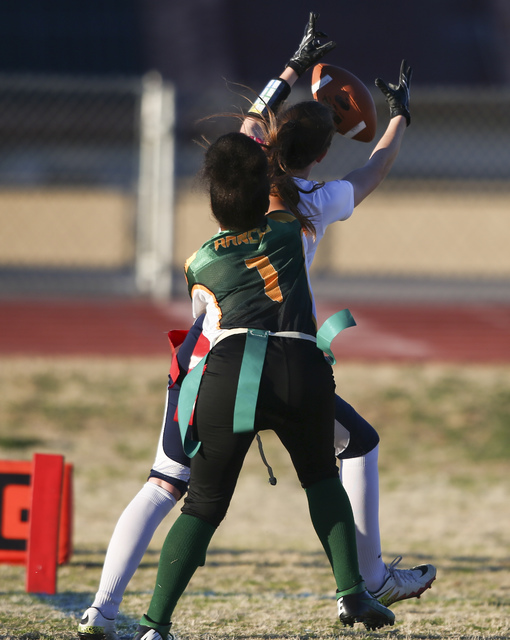 Coronado’s Reagan Raimer (10) reels in a touchdown as Rancho’s Kayla Holbert (1) ...