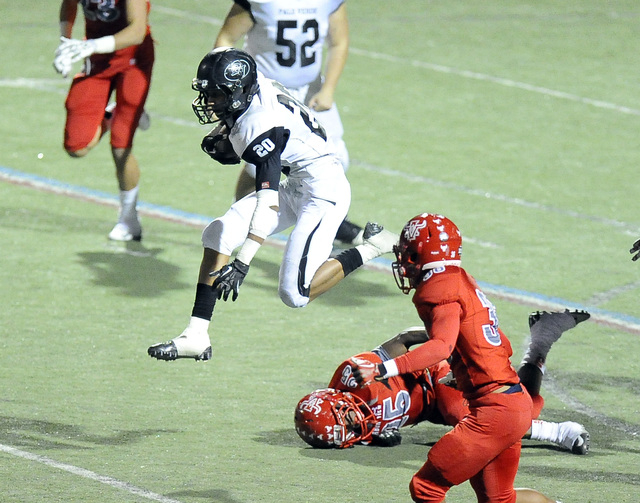 Palo Verde running back Isaac Woods (20) hurdles over Arbor View’s Elijah Clark (25) d ...