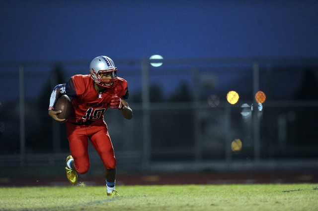 Liberty punter Damahny Whittle runs for a first down on a fake punt in the first quarter on ...