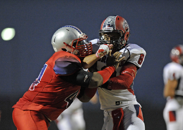 Liberty defensive lineman Alofana Tevaseu, left, battles Coronado linebacker Kainoa Granstro ...