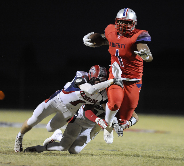 Coronado safety Koy Harris (1) and strong safety Jad Cheetany, right, tackle Liberty tight e ...