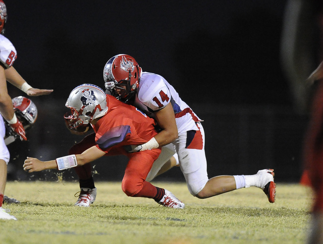 Coronado linebacker Jordan Rudd (14) sacks Liberty freshman quarterback Kenyon Oblad in the ...