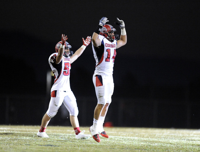 Coronado linebacker Jordan Rudd (14), and linebacker Aaron Cotton (52) celebrate after Rudd ...