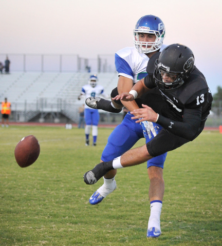 Green Valley’s Brayon Williams slaps the ball away from Palo Verde’s Jordan Brun ...