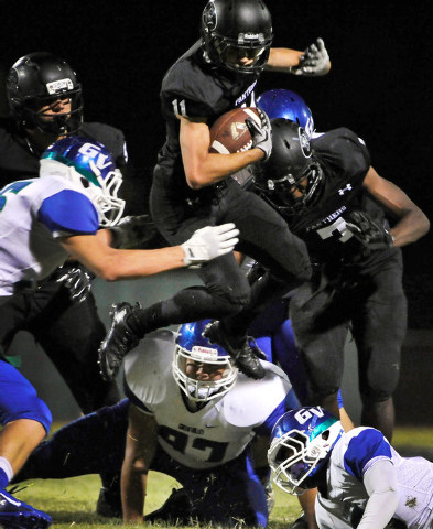 Palo Verde’s Ty Fuller (11l jumps over Green Valley’s Spencer Racelis (97) durin ...