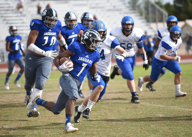 Desert Pines Isaiah Morris (7) runs the ball against South Tahoe during their 3A state semif ...