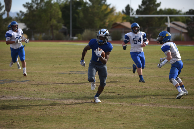 Desert Pines Isaiah Morris (7) runs the ball against South Tahoe during their 3A state semif ...