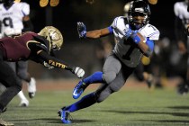 Desert Pines sophomore running back Isaiah Morris sidesteps a tackle attempt by Faith Luther ...