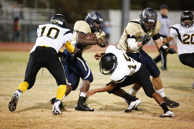 Clark’s Amir Boone (10) and Brendon Jackson (15) go in for a tackle on a Cheyenne play ...