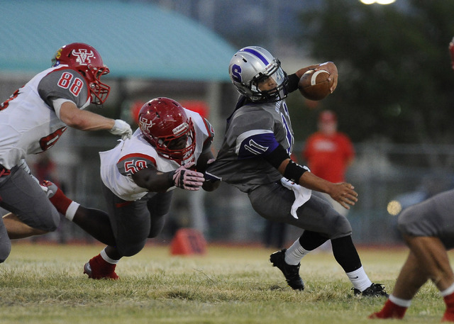 Arbor View linebacker Tyreace Smith, left, tackles Silverado running back Jarrett Alipio (1 ...