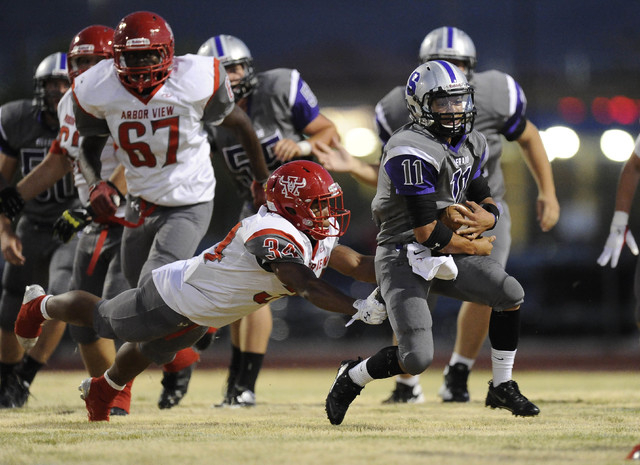 Silverado running back Jarrett Alipio (11) breaks the tackle of Arbor View linebacker Herman ...