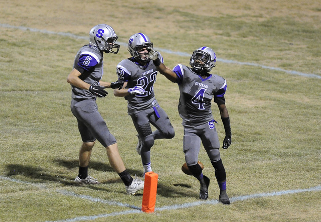 Silverado running back Deyon McKinney (4) celebrates a touchdown with teammates Robert Richa ...