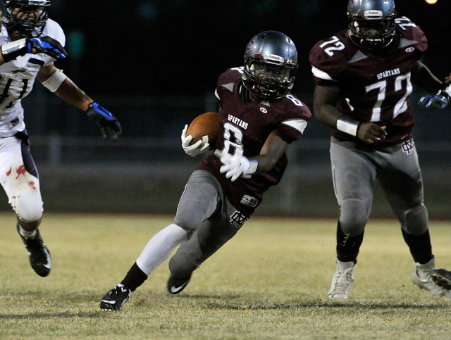 Cimarron-Memorial’s Maurice Bennett (8) breaks free from the pack against Cheyenne on ...