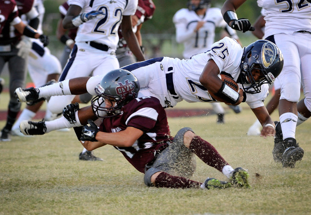 Cheyenne’s Darius Haigler (25) is tripped up by Cimarron-Memorial’s Stone Steven ...