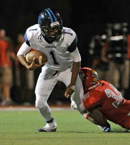 Arbor View’s Herman Gray, right, grabs the leg of Canyon Springs quarterback Bradley A ...