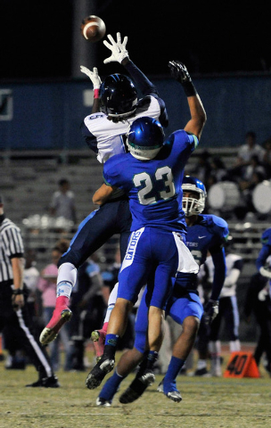 Canyon Springs’ Kujuan Casey, grabs a reception over Green Valley’s Albert Lake ...