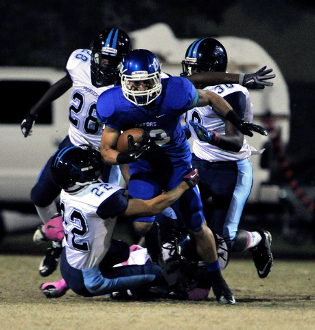 Green Valley’s Albert Lake runs the ball against Canyon Springs on Friday. Lake rushed ...