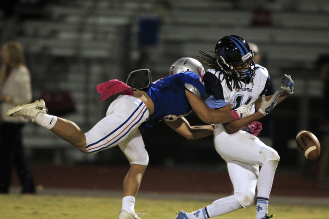 Liberty defensive back Preston Pavlica breaks up a pass intended for Canyon Springs’ C ...