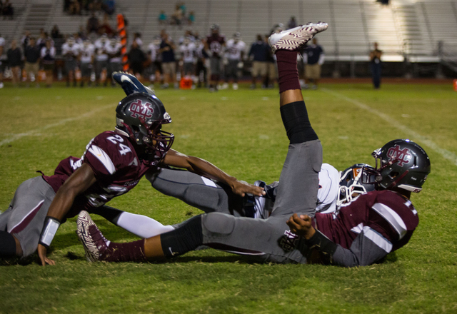 Cimarron-Memorial’s Rasaan Mills and Joe Tito attempt to gain control of a loose ball, ...