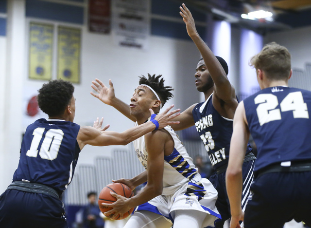 Sierra Vista forward Chris McCoy (23) looks for an open pass while surrounded by Spring Vall ...