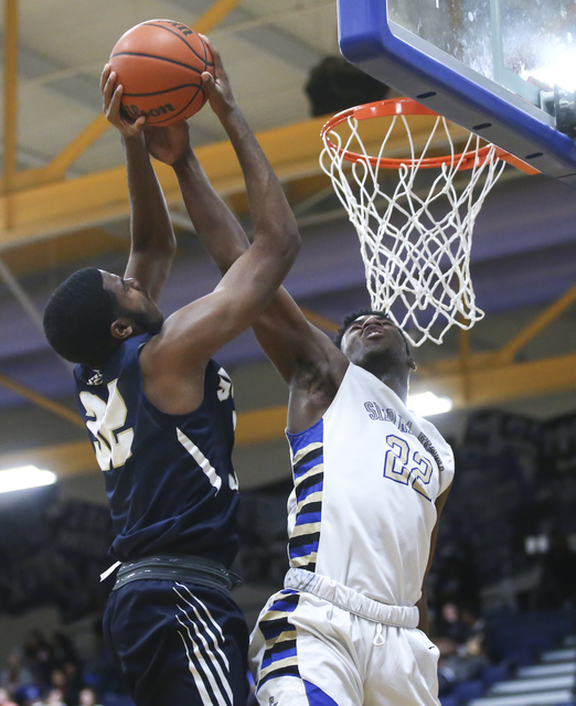 Sierra Vista forward Lerone Gibson (22) blocks a shot from Spring Valley center Sean Sampson ...