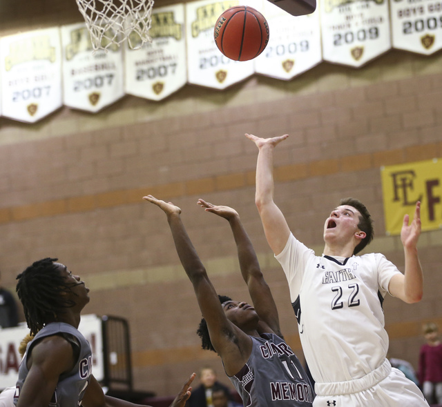 Faith Lutheran’s Connor Nichols (22) goes up for a shot over Cimarron-Memorial guard J ...