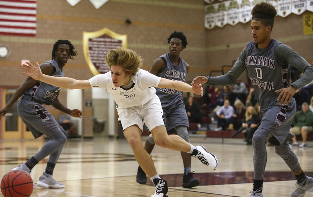 Faith Lutheran forward Nic Maccioni (24) is tripped up while playing against Cimarron-Memori ...