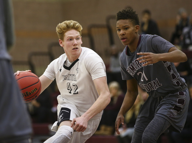 Faith Lutheran Elijah Kothe (42) drives past Cimarron-Memorial’s Karion Harrell (21) d ...