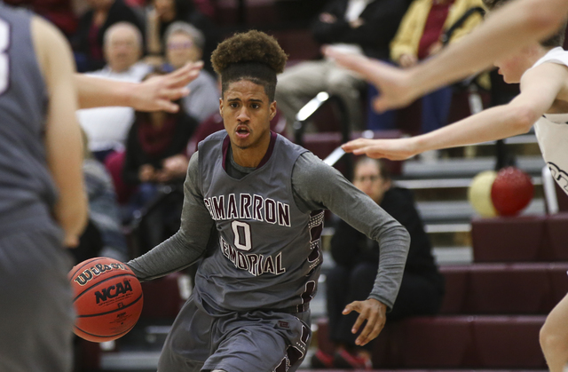 Cimarron-Memorial’s Kamakana Winquist (13) drives to the basket during a basketball ga ...