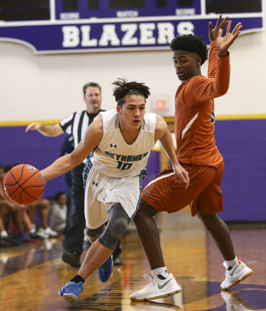 Silverado’s Cameron Nagy (10) gets past Legacy’s Chris White (5) during a basket ...