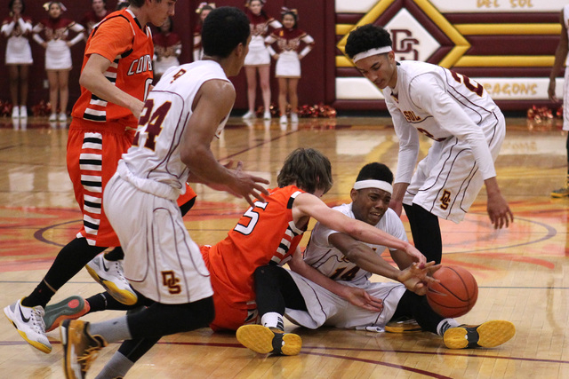 Del Sol forward Brian Greer shoves a loose ball away from Chaparral forward Ben Kirschbaum o ...