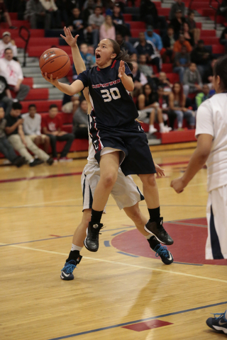 Coronado senior Dajah Washington (30) drives to the basket during the first half on Thursday ...