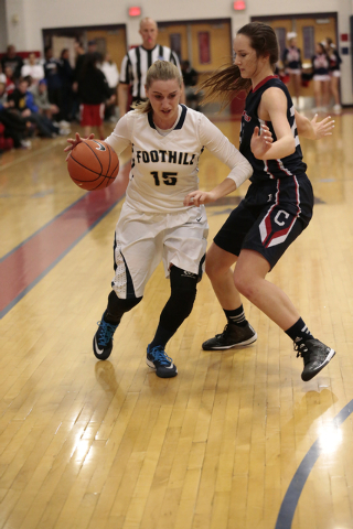 Foothill senior Nicole Benson (15) drives to the basket while being defended by Coronado sen ...