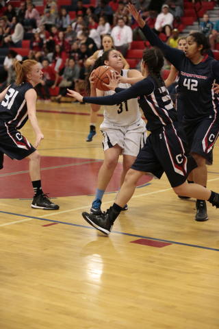 Foothill freshman Bri Rosales (31) attempts a shotwhile surround by Coronado’s Dajah W ...