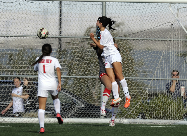 Arbor View forward Haylee Niemann, center, collides with Coronado goalkeeper Rachel Morris d ...