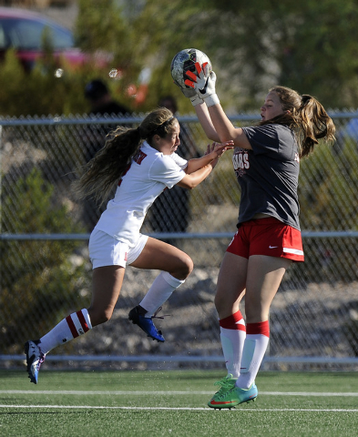 Coronado goalkeeper Shannon Heenan (6) collides with Arbor View midfielder Haley Vicente dur ...