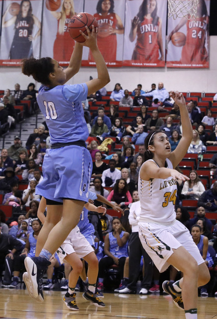 Centennial’s Jayden Eggleston (10) shoots over Bishop Manogue’s Julia McElwee (3 ...