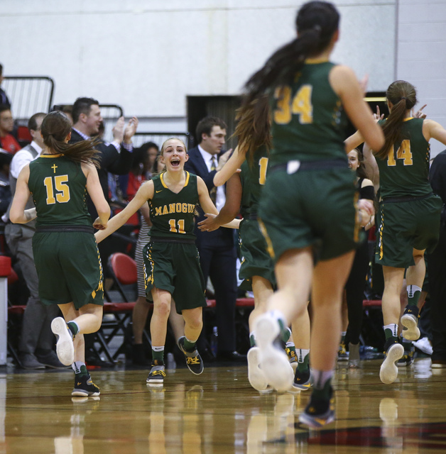 Bishop Manogue players react after defeating Foothill 74-37 in the Class 4A girls state bask ...