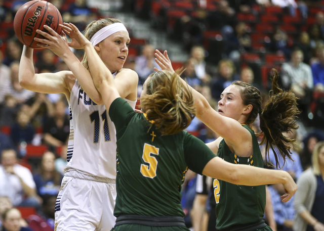 Bishop Manogue guard Malia Holt (C) (5) and forward Maddie Camacho (2) defend against Foothi ...