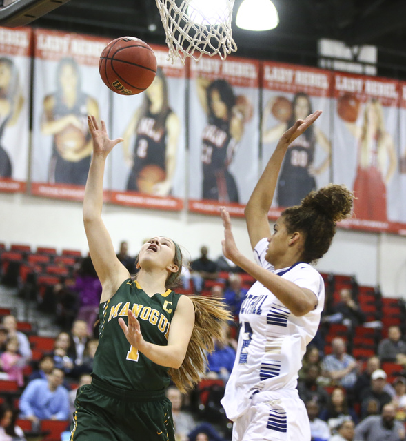 Bishop Manogue guard Katie Turner (1) goes to the basket over Foothill’s Rae Burrell ( ...