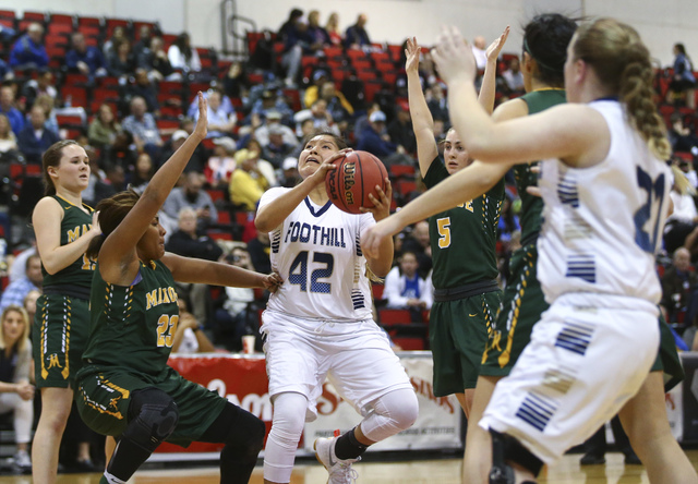 Foothill’s Trinity Betoney (42) drives to the basket between Bishop Manogue defends du ...