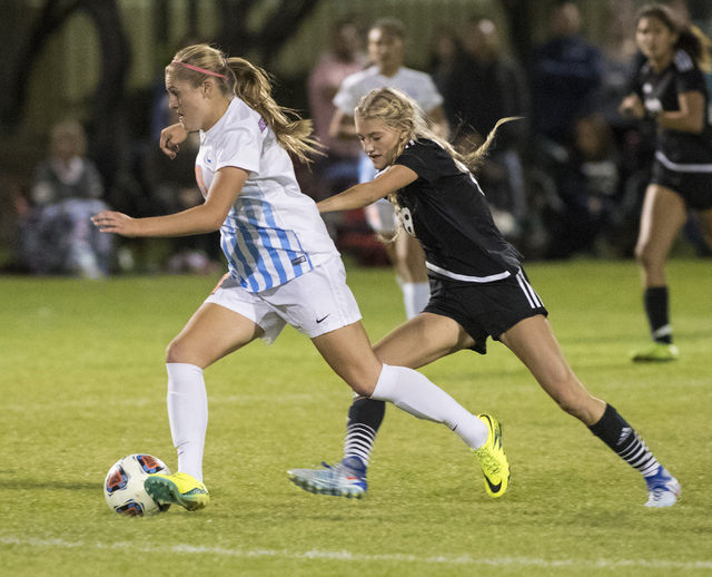 Arlie Jones (19) from Bishop Gorman High School battles for the ball against Alexis Lloyd (8 ...