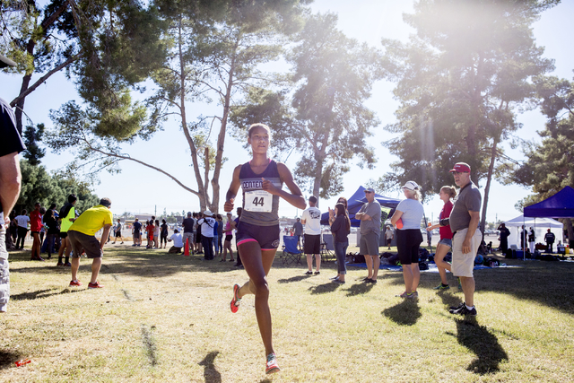 Centennial junior Alexis Gourrier leads the pack of runners on the second lap of the 3.1 m ...