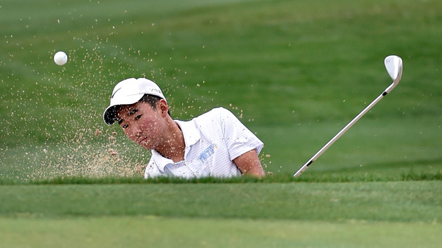 Foothill High School senior golfer Andrew Chu chips out of a bunker near the 11th green duri ...