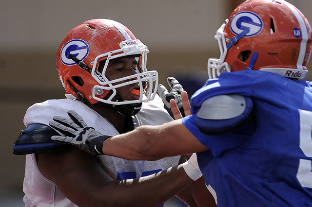 Bishop Gorman senior offensive lineman Jackson Perry, left, ties up linebacker Gavin Panciro ...